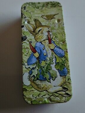 Illustrated Peter Rabbit Slide Bunny Tin with Blue Jacket and Green Background